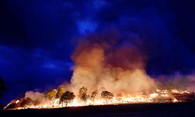 Bushfire at Grampians national park, Victoria, Australia. Extreme weather can lead to more severe and frequent disasters. Global warming has increased five-fold the probabilities that Australians will bake in record hot summers, according to research from the University of Melbourne. Photo: Jason Edwards / Newspix / Rex Feat