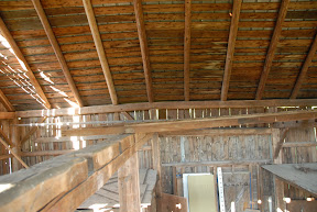 The bend in the plate as seen inside of the barn.