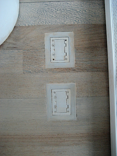 The living room is equipped with floor outlets for lamps although I'm not sure I want lamps in the living room because you will see their reflections in the windows at night.