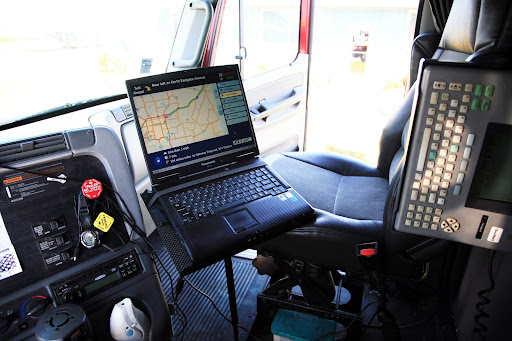 McGuire's laptop computer, left, is used for GPS and directions; the device to the right is used to communicate with his dispatcher. (Photo Credit: Alex Crowder)