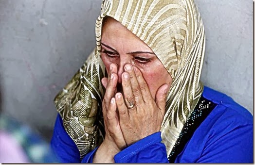 A Syrian woman grieves. (Photo- © Reuters)