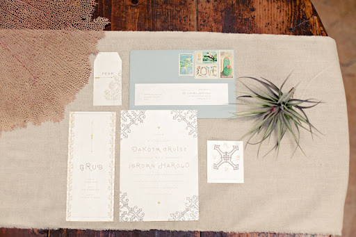 The invitation suite incorporated subtle nautical touches like a compass rose. The invitation suite incorporated subtle nautical touches like a compass rose.