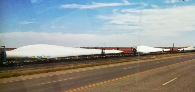 Windmill blades on a passing train (couldn't get that bug smear off)
