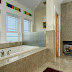 The master bath also includes a fireplace, jacuzzi and colorful stained glass.