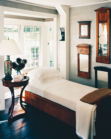 This Biedermeier bed is complimented by the matching mirrors and side table.