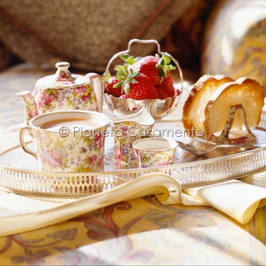 Teapot, strawberry and loaf of bread on table Teapot, strawberry and loaf of bread on table