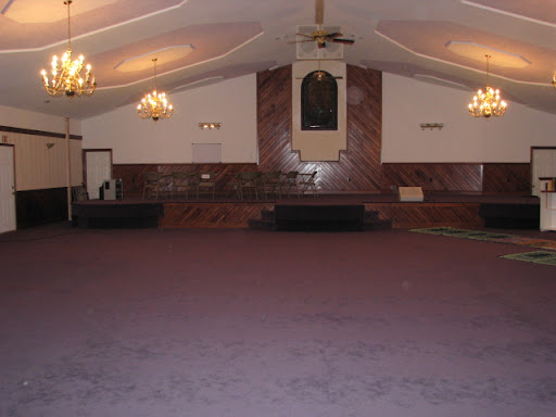 The building was formerly a church; it has a stage which is not used today.  (Photo credit:  Jennifer Moore)