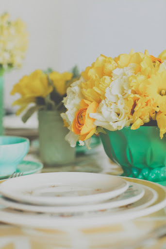 Yellow flowers, mixed with marigold blooms, feel soft and sunny.
