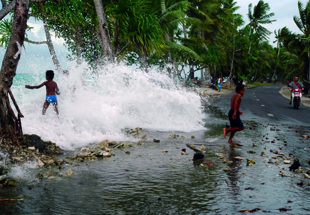 A wave crashes ashore in Tuvalu. peacepalacelibrary-weekly.blogspot.com