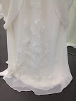 A beautiful floral detail on hem of this gown. A beautiful floral detail on hem of this gown.