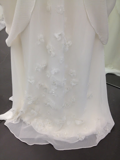 A beautiful floral detail on hem of this gown. A beautiful floral detail on hem of this gown.