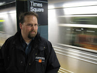 Mark with subway train in background.