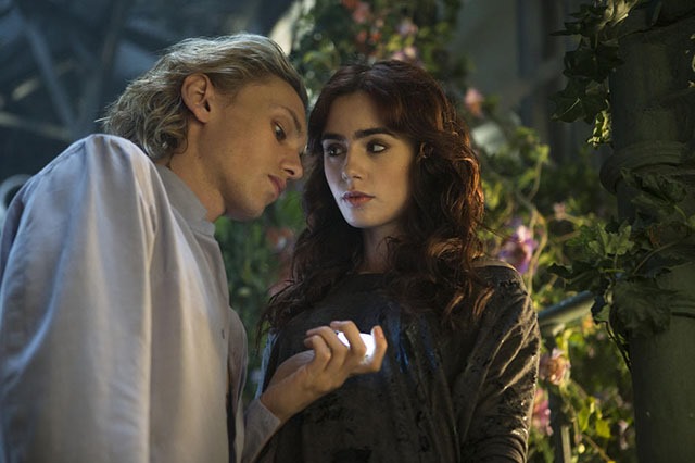 Jace (Jamie Campbell Bower) tells (Lily Collins) about his childhood in Screen Gems fantasy-action THE MORTAL INSTRUMENTS: CITY OF BONES.