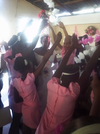 The dancing of girls coming down the isle at the haitian wedding The dancing of girls coming down the isle at the haitian wedding