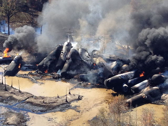 A tanker train that derailed and caught fire in western Alabama outside Aliceville was carrying 2.7 million gallons of crude oil, 9 November 2013. Photo: Bill Castle / Associated Press