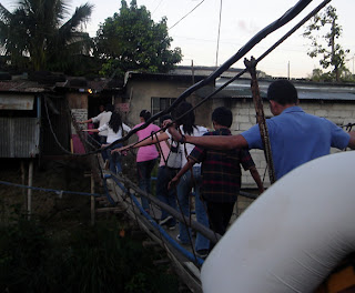 February 22: Students cross a makeshift bridge used as shortcut from Kurt's house.