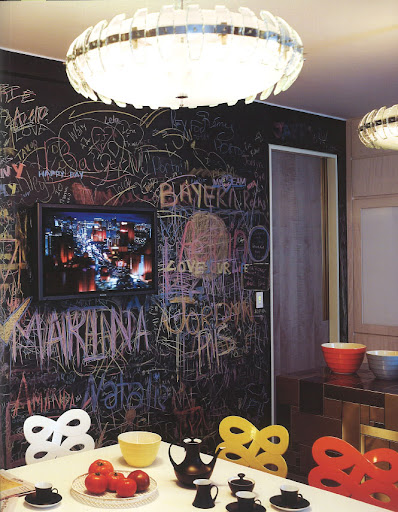 Matte black wall paint doubles as a giant chalkboard in this modern kitchen.