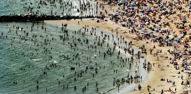 According to the National Oceanic and Atmospheric Administration, the past year through June 2012 has been the hottest year in the continental U.S. since modern record-keeping started in 1895. In this aerial view, New Yorkers flocked to Coney Island to try to beat the heat in early August. Mario Tama / Getty Images