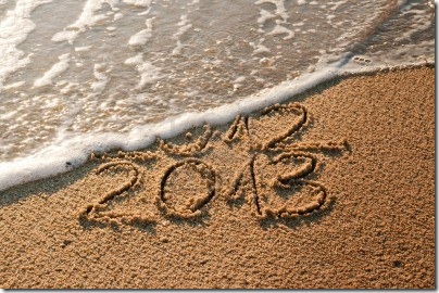 15506184-2012-and-new-year-2013-coming--waves-erase-year-2012-on-the-sandy-beach