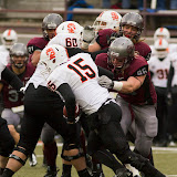 Idaho State quarterback Kevin Yost is chased by Grizzlies Josh Harris (#96) and Zack Wagenmann, while Jordan Tripp watches from afar.  Tripp ultimately made the tackle, a testament of his ability to make plays regardless of field position.

Washington-Grizzly Stadium in Missoula, Mont., October 27th, 2012.