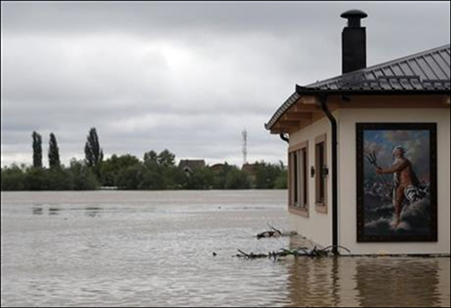 A flooded restaurant with a picture of Poseidon - 'God of the Sea' by the bank of the Sava river in Sremska Mitrovica, 90 kilometers west of Belgrade, Serbia, Saturday, 17 May 2014. Record flooding in the Balkans leaves at least 20 people dead in Serbia and Bosnia and is forcing tens of thousands to flee their homes. Three months' worth of rain has fallen on the region in just three days, and meteorologists say the flooding is the worst since records began 120 years ago. Photo: Darko Vojinovic / AP Photo