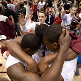 Jamar, Cherry, and Steward huddle up at the end of the game.