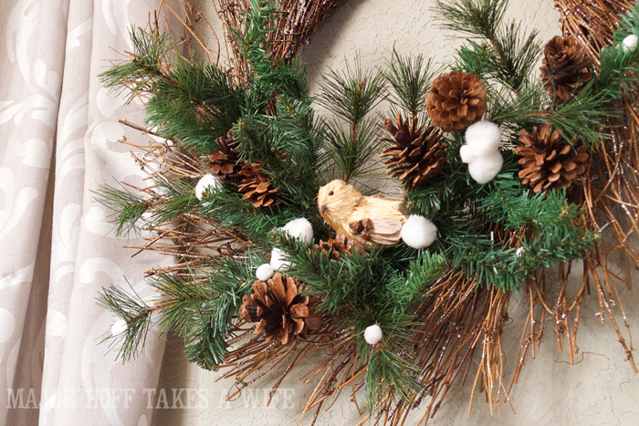 Winter Wonderland Nature inspired Wreath. World Market inspired wreath. A fun twist on a Christmas wreath. Make a winter wreath that will last all season long and well past. This cute grapevine wreath is adorned with a tiny bird, pinecones, greenery and pom poms. You won't believe how cheap and easy this was to make! And so simple! #Christmas #winter #holiday #wreath #nature #knockoff Winter Wonderland Nature inspired Wreath. World Market inspired wreath. A fun twist on a Christmas wreath. Make a winter wreath that will last all season long and well past. This cute grapevine wreath is adorned with a tiny bird, pinecones, greenery and pom poms. You won't believe how cheap and easy this was to make! And so simple! #Christmas #winter #holiday #wreath #nature #knockoff