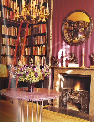 The library in Philip Hewat-Jaboor's London flat pays tribute to Neoclassicism in all its expressions, whether period, as exemplified by the fossil-marble mantelpiece attributed to the renowned architect Sir John Sloane, or modern, as represented by the imperial porphyry-top center table designed by Pierre-Herve Walbaum and inspired by a table at the Grand Trianon. (Regency Redux, Rizzoli)