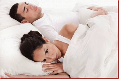 Couple In Bed, Men Sleeping And Woman Lying Disappointed by photostock 10034198