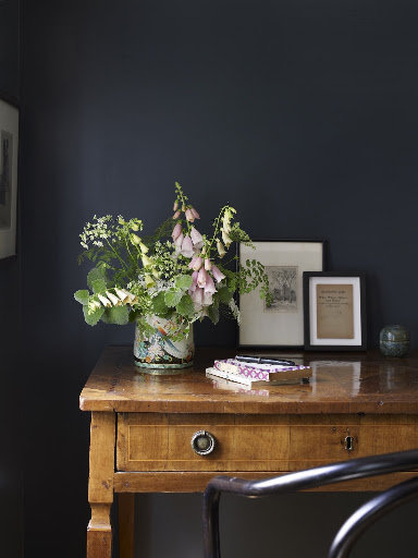 The pastels in this arrangement look great in against the dark blue wall.