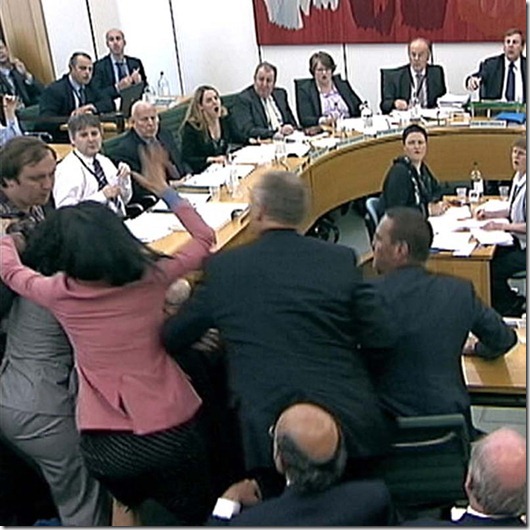 Wendi Deng unges towards a man trying to attack her husband, News Corp Chief Executive and Chairman Rupert Murdoch, during a parliamentary committee hearing on phone hacking at Portcullis House in London...Wendi Deng (2nd L) lunges towards a man trying to attack her husband, News Corp Chief Executive and Chairman Rupert Murdoch, during a parliamentary committee hearing on phone hacking at Portcullis House in London July 19, 2011.   REUTERS/Parbul TV via Reuters Tv (BRITAIN - Tags: CRIME LAW MEDIA BUSINESS) FOR EDITORIAL USE ONLY. NOT FOR SALE FOR MARKETING OR ADVERTISING CAMPAIGNS