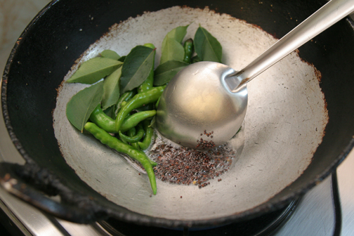 Dry fry chilies and curry leaves, then add oil and mustard seeds.