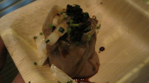 That's black truffle atop a foie gras dumpling.  Chef Ming went big.