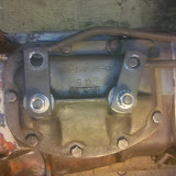 You can see how the attachment is made between the rods and the transmission arms - the rod makes a 90 degree turn into that hole. There are plastic bushings (teflon?) that smooth the joint out, and the rods are then secured with a spring clip.
