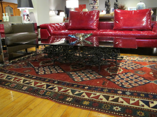 A cocktail table is in the style of Ibram Lassaw (circa 1960s). So detailed with a decorative black sculpture base and smoked glass top.