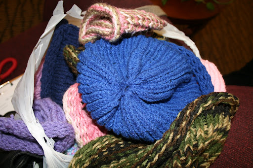 The donated caps spill out of a bag; all sizes of caps were donated to cancer patients.  The children who knitted the caps range in age from five to 10 years old. (photo credit: James Mulvenon)