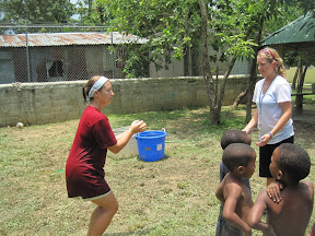 Kristen and Lara demonstrating how to throw a water balloon.