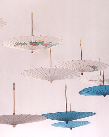 Inexpensive paper parasols can be hung from the ceiling for a stylish, exotic vibe. (marthastewartweddings.com) Inexpensive paper parasols can be hung from the ceiling for a stylish, exotic vibe. (marthastewartweddings.com)