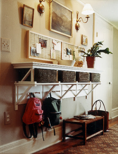 This set up is great for families with children because the pegs are at the perfect height. The upper shelf serves as the adult space, with cork boards for hanging important reminders.