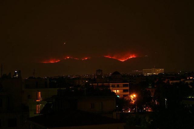 Fire in progress at Parnitha Mount, outskirts of Athens, Greece, on the night of 28 June 2007. Photo taken from 16km away. George Havlicek / wikipedia.org