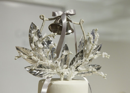The beautiful cake topper made with millinery flowers and leaves. The beautiful cake topper made with millinery flowers and leaves.