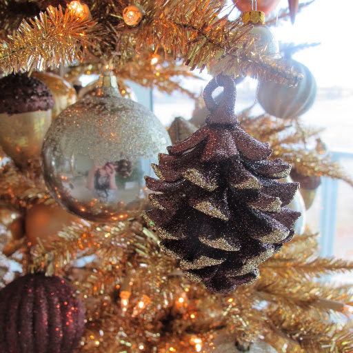 A close-up photo of a glittered pinecone ornament.