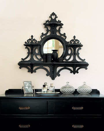 I love Martha's black bureau. An inexpensive mirror, framed in whimsical fretwork, became a glamorous accent for the bedroom when its old varnish was replaced with a deep, charcoal-gray paint. I love Martha's black bureau. An inexpensive mirror, framed in whimsical fretwork, became a glamorous accent for the bedroom when its old varnish was replaced with a deep, charcoal-gray paint.