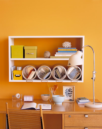 Recycled paint cans make convenient cubbies for mail and office supplies.