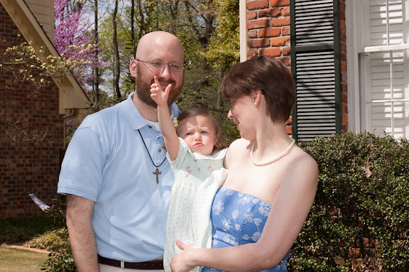 Sam trying to pick daddy's nose.