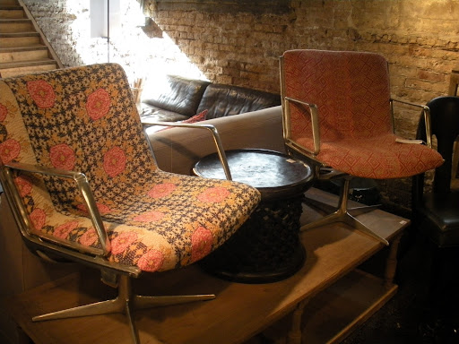 Retro swivel chairs and a low side-table look relaxed and comfortable.