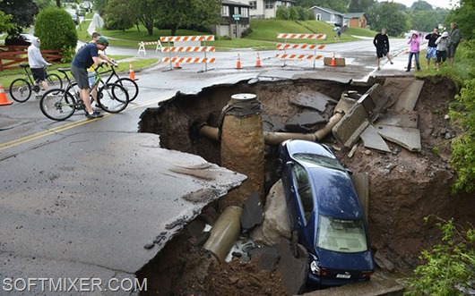 A car sits in a giant sinkhole in Duluth, Minn. Wednesday, June 20, 2011. Residents evacuated their homes and animals escaped from pens at a zoo as floods fed by a steady torrential downpour struck northeastern Minnesota, inundating the city of Duluth, officials said Wednesday. (AP Photo/The Star Tribune, Brian Peterson)  MANDATORY CREDIT; ST. PAUL PIONEER PRESS OUT; MAGS OUT; TWIN CITIES TV OUT