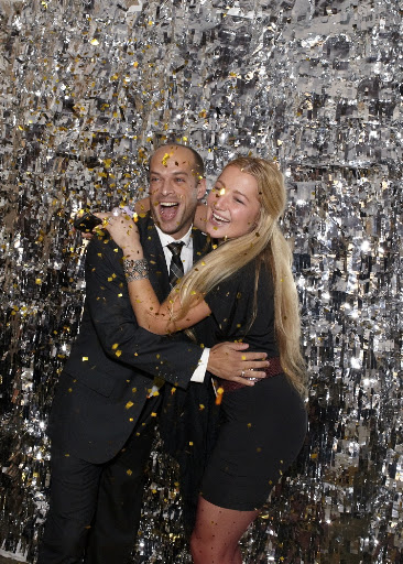 Partygoers lined up to smile and throw confetti.