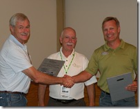 Barry and Mike receiving award from Ed