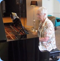 Dorothy Waddel playing the grand piano. Photo courtesy of Dennis Lyons.